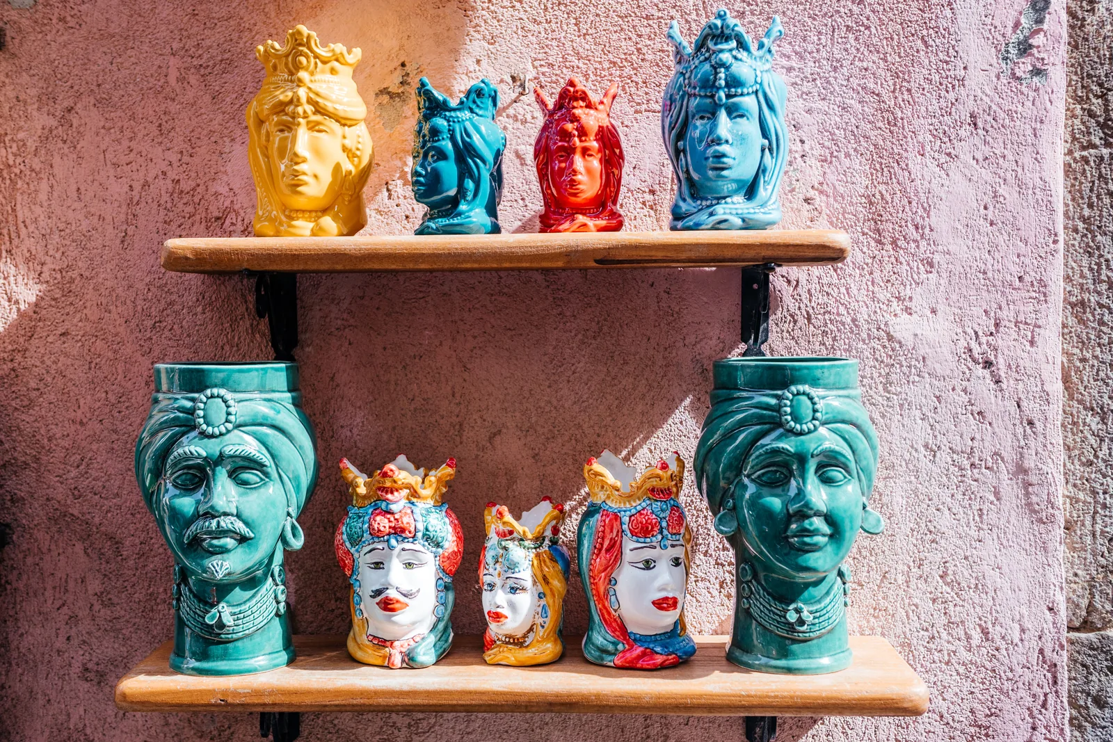 Painted Sicilian ceramic heads on a shop shelf in Cefalù