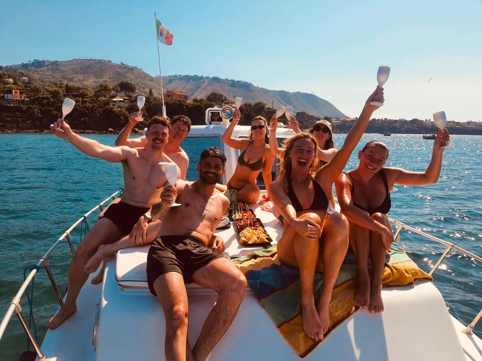 Guests on the bow raising their glasses during the onboard aperitivo