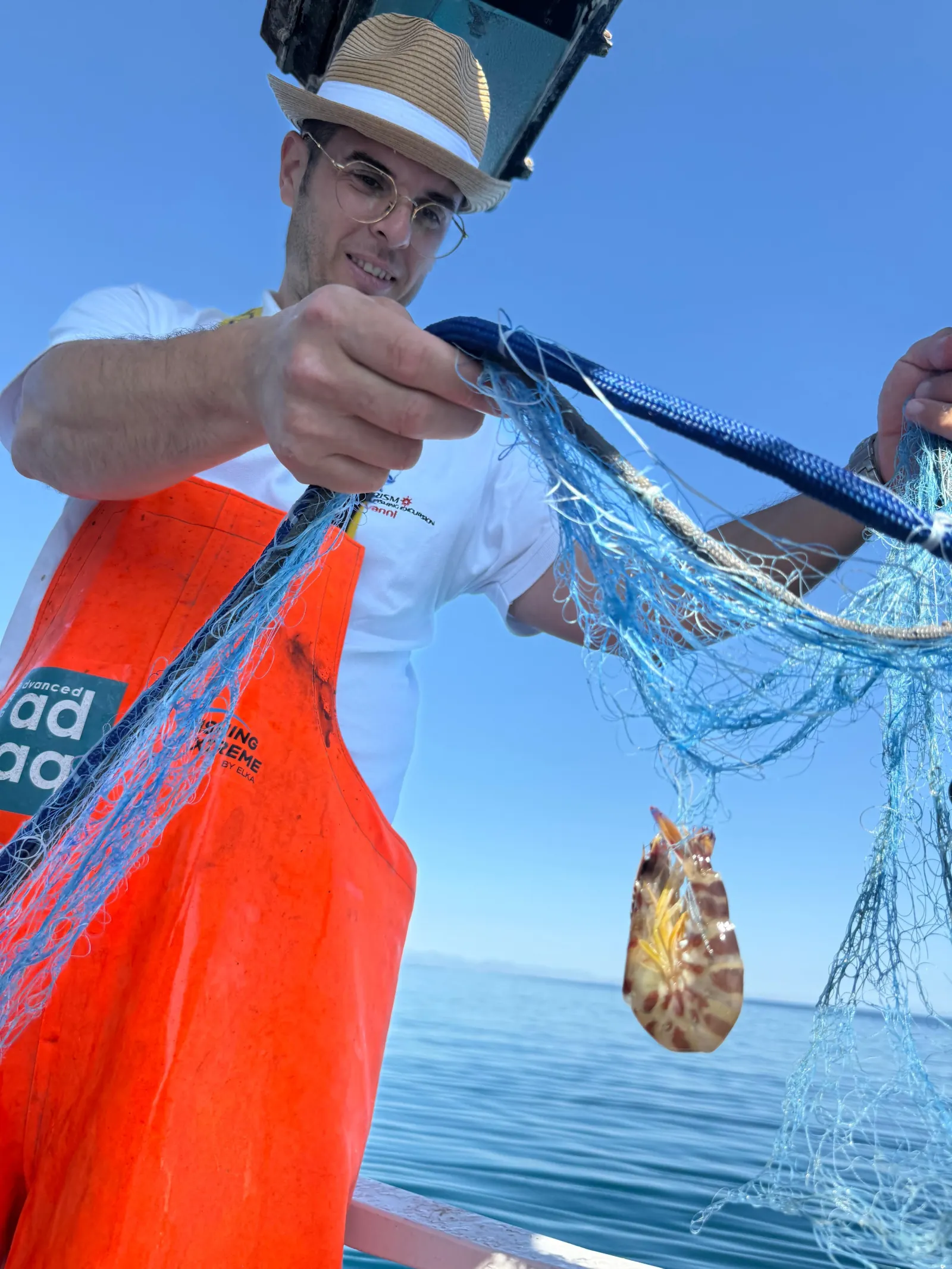 The fisherman hauling a net over the side with the morning's catch in it