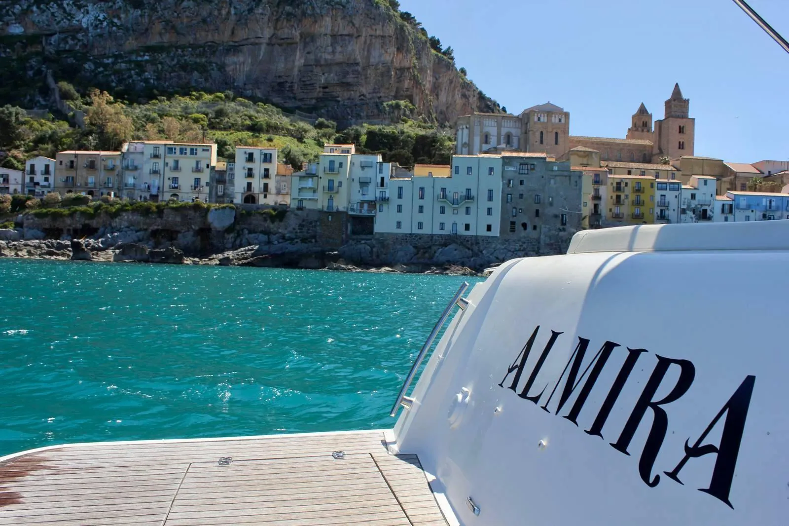 The yacht's transom with ALMIRA lettered across it, the old town in the background