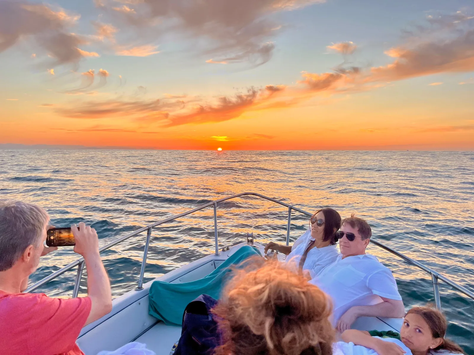 Guests on the bow watching the sun go down off the Cefalù coast